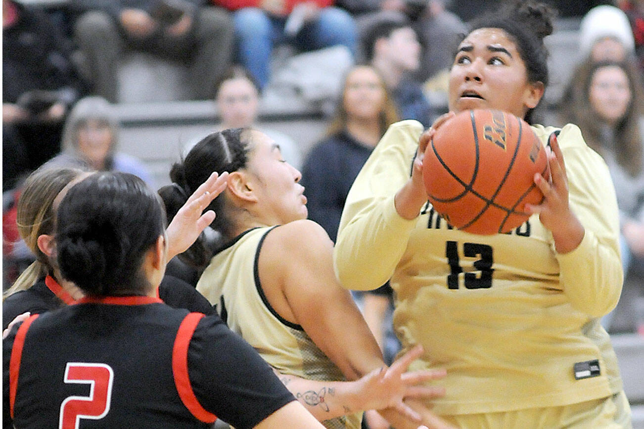 KEITH THORPE/PENINSULA DAILY NEWS 
Peninsula's Jelissa Julmist, right, looks for her chance at the goal as teammate Jenilee Donovan, center, fends off the Olympic defense, including Nohea Morrison, left, on Saturday at Peninsula College.