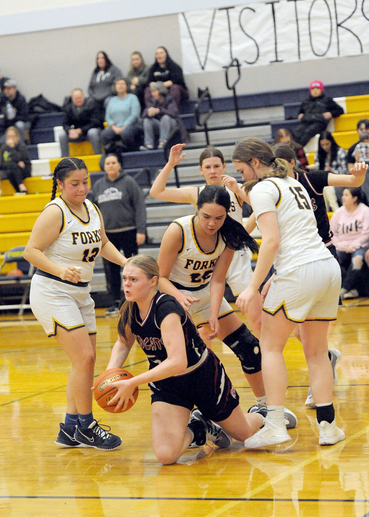 Forks players, from left, Janessa Ramos, Brynn Daniels and Fynlie Peters trap Ocosta’s Anna Davis Friday night in Forks during senior night for the Spartans. Looking on is Forks’ Bailey Johnson. Forks defeated Ocosta 59-31. (Lonnie Archibald/for Peninsula Daily News)