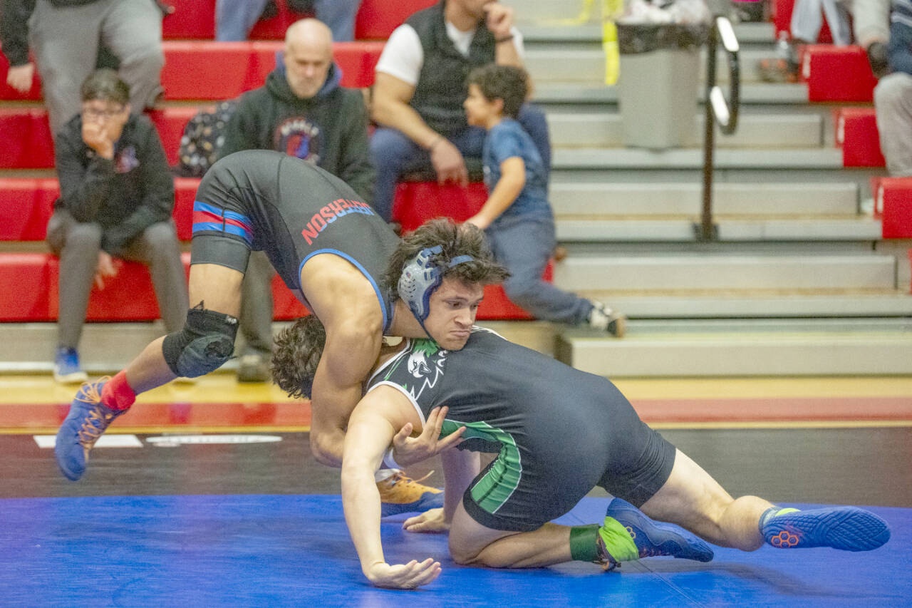 East Jefferson Rival grappler Manaseh Lanphear Ramirez tries to flip his Klahowya opponent Sean Price during the Nisqually League subregionals at Port Townsend High School on Saturday. Ramirez won the 150-pound weight class. (Steve Mullensky/for Peninsula Daily News)