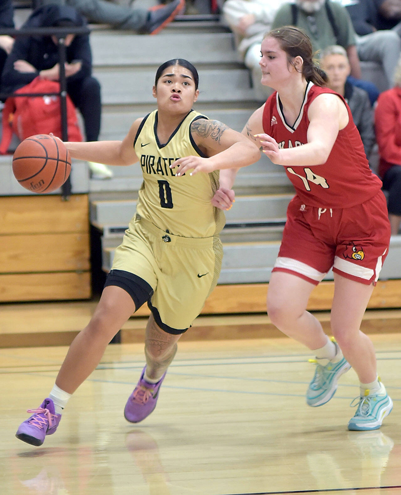 Peninsula’s Ciera Agasiva, left, slips around the defense of Skagit Valley’s Jenae Rhoads on Wednesday at Peninsula College. (Keith Thorpe/Peninsula Daily News)