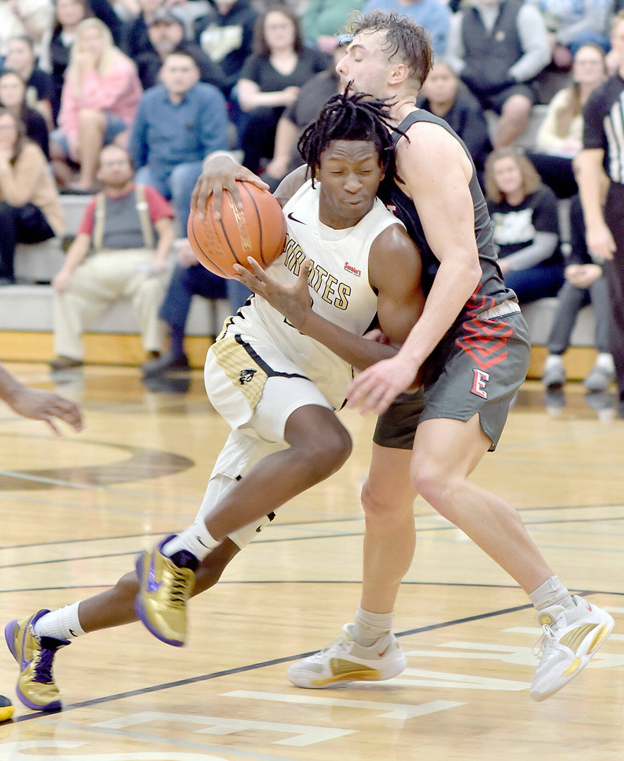 Peninsula’s Ese Onakpoma, left, shoulders into Everett’s Derek Smith on Saturday in Port Angeles. (Keith Thorpe/Peninsula Daily News)