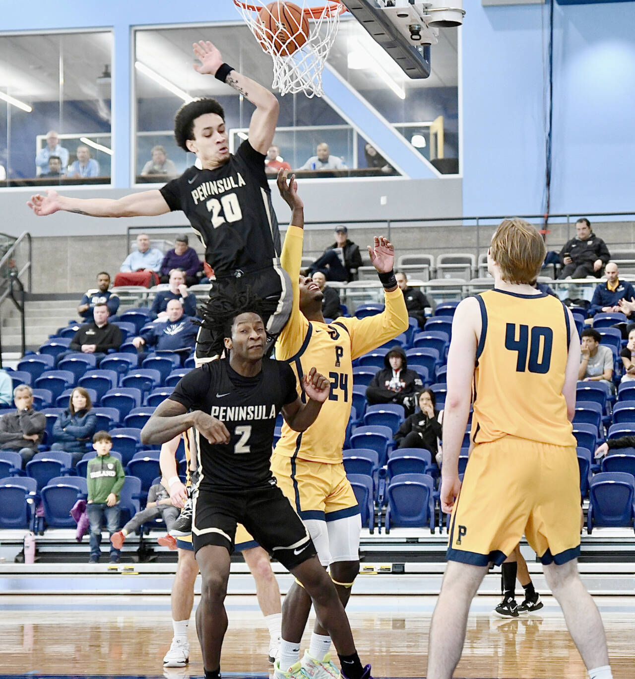 Peninsula College’s DeShawn Rushmeyer (20) and Ese Onakpoma (2) battle for a rebound with Portland’s Nydir Hodges (24) and Josh Lincoln (40) in the opening round of the NWAC tournament in Pasco on Wednesday. (Jay Cline/Peninsula College)