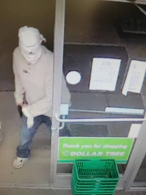 Surveillance video footage shows a man brandishing a gun at the Dollar Tree store in Port Angeles. (Clallam County Sheriff’s Office)