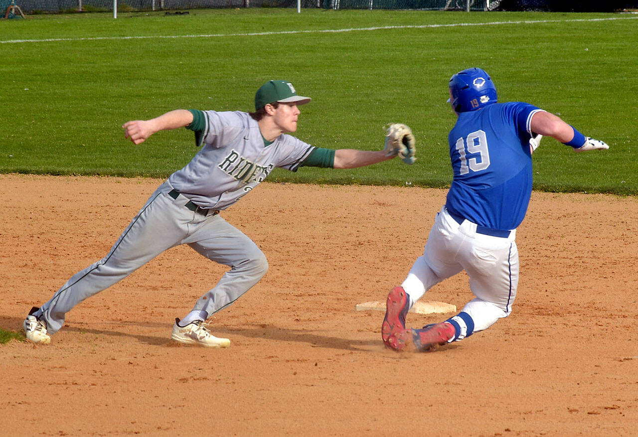 Port Angeles shortstop Alex Angevine, left, catches Olympic’s Landon Nicholson on a second base steal attempt for an out during Thursday’s game at Port Angeles Civic Field. (KEITH THORPE/PENINSULA DAILY NEWS)