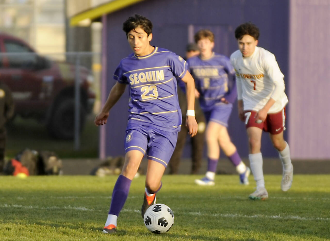 Sequim’s Guillermo Salgado dribbles the ball against Kingston in Sequim on Tuesday. (Michael Dashiell/for Peninsula Daily News)