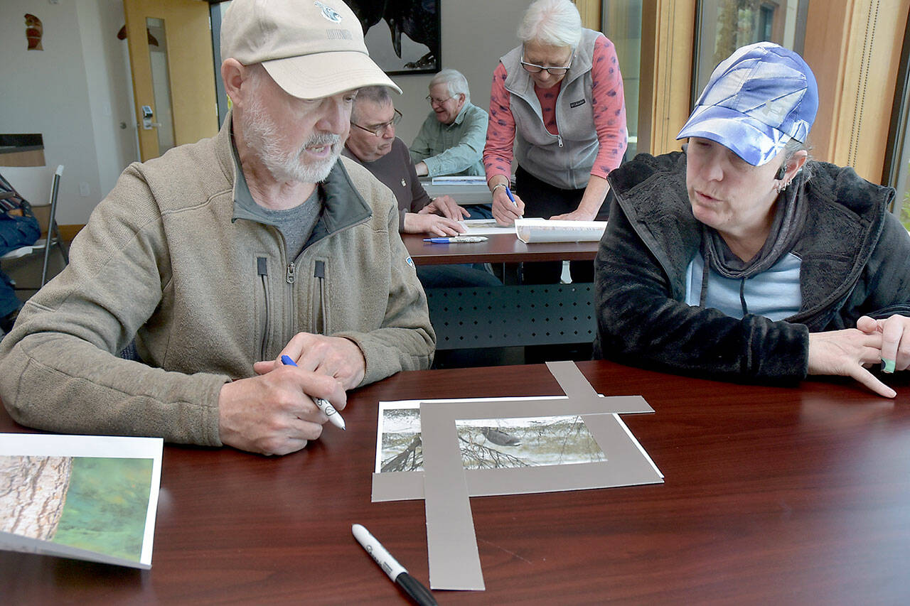 Dave Swinford of Sequim, left, and Marlana Ashlie of Victoria take part in a workshop on Saturday about cropping bird photos for best presentation during Saturday’s Olympic Birdfest. (Keith Thorpe/Peninsula Daily News)