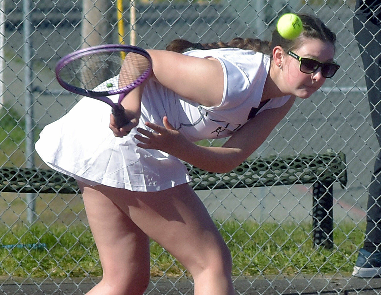 Port Angeles’ Waverly Mead leans low for the return during her singles match against Bainbridge’s Izzy Wallin on Wednesday afternoon in Port Angeles. (Keith Thorpe/Peninsula Daily News)