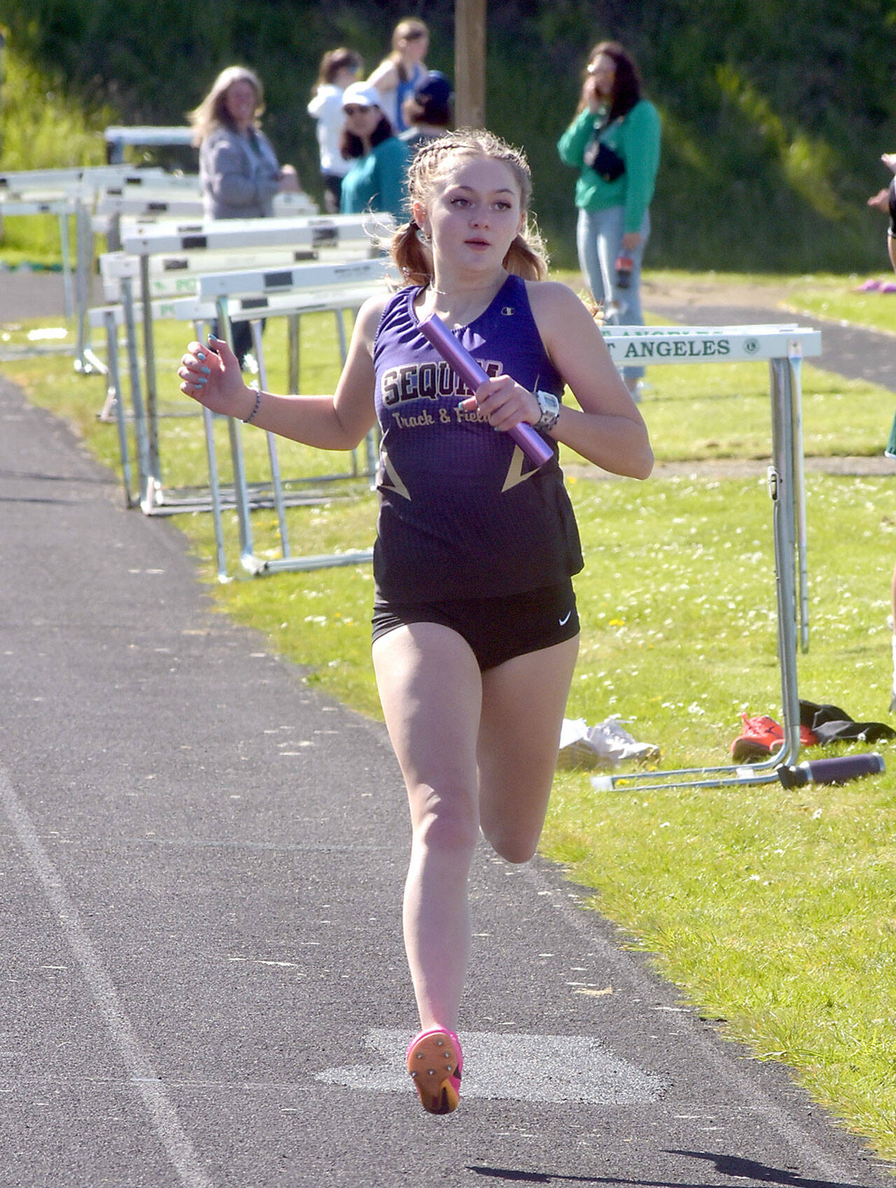 KEITH THORPE/PENINSULA DAILY NEWS Sequim’s Bailey Stein crosses the finish line on the anchor leg of the girls 4x200 race on Thursday at Port Angeles High School.