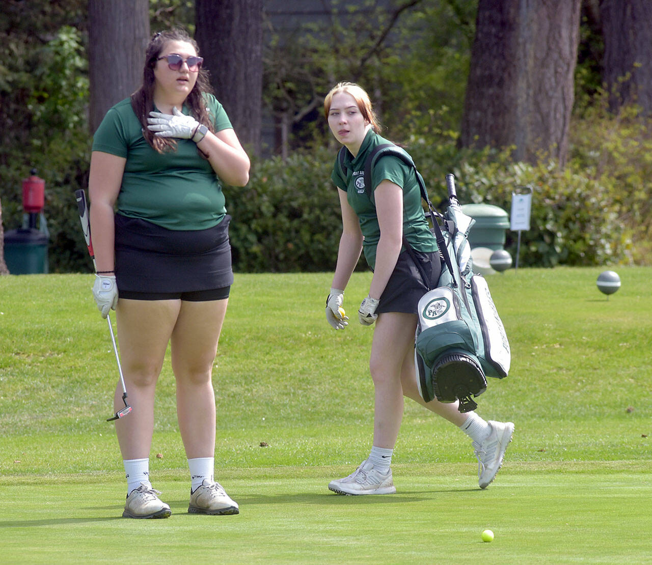 KEITH THORPE/PENINSULA DAILY NEWS Port Angeles’ Mia Neff, left, and Claire Osterberg of Port Angeles plan their putts on the 11th Hole at Peninsula Golf Course during Tuesday’s Duke Streeter Invitational.