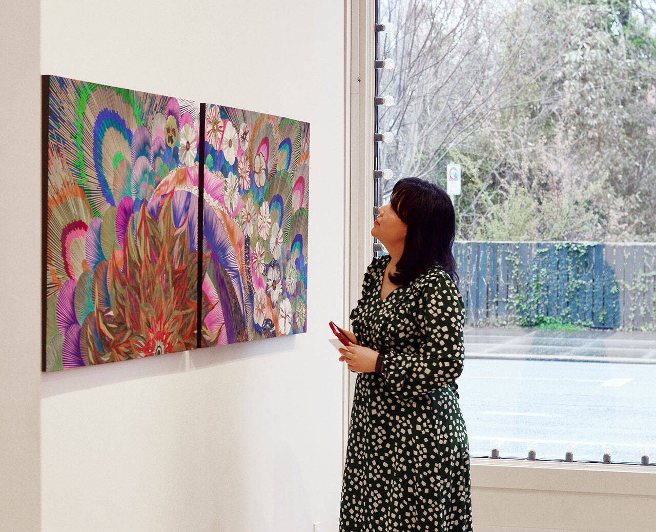 Xin Xin admires mosaics by fellow “A Warm Embrace” artist Naoko Morisawa at Jeanette Best Gallery in downtown Port Townsend. (Northwind Art)