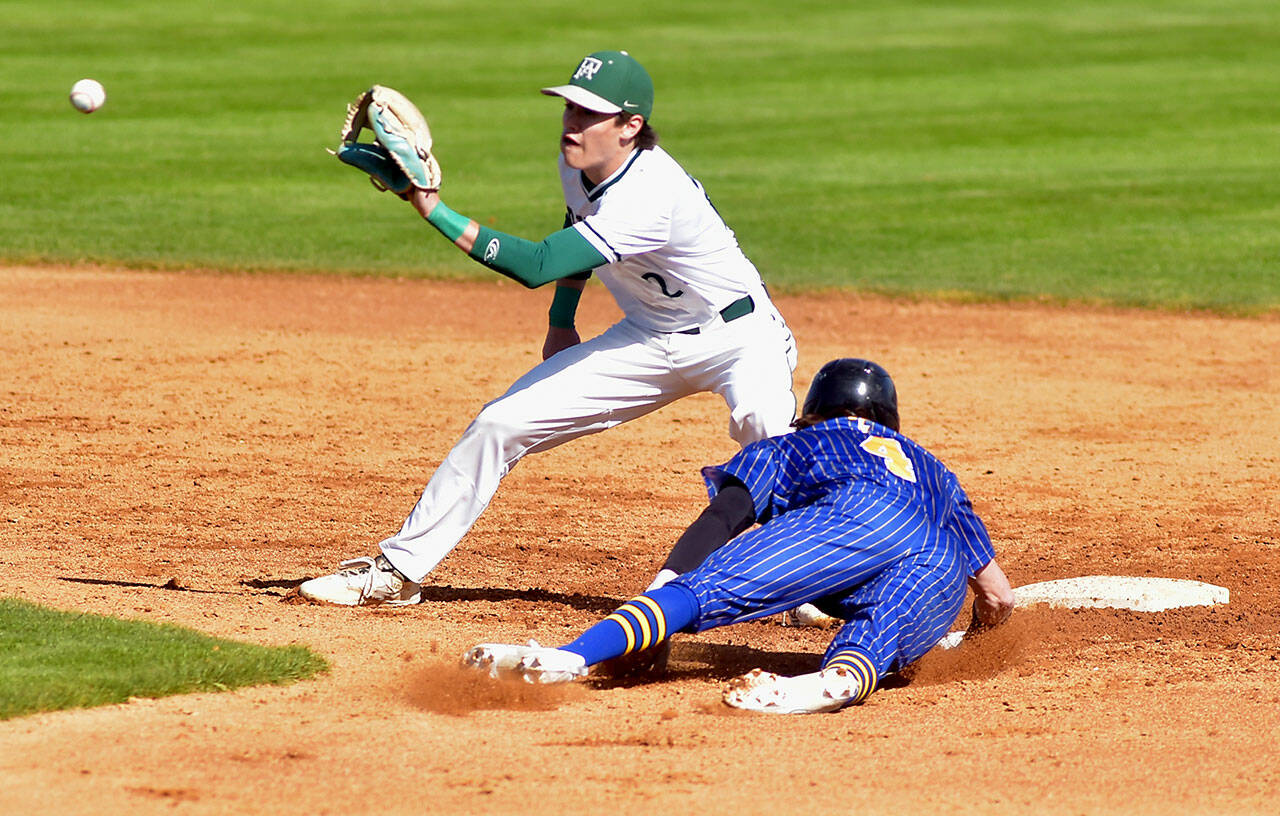 Port Angeles shortstop Alex Angevine, left, receives the throw from catcher Luke Flodstrom to nail Fife’s Kaden Cretti trying to steal second base during Tuesday’s playoff game at Port Angeles Civic Field. (KEITH THORPE /PENINSULA DAILY NEWS)