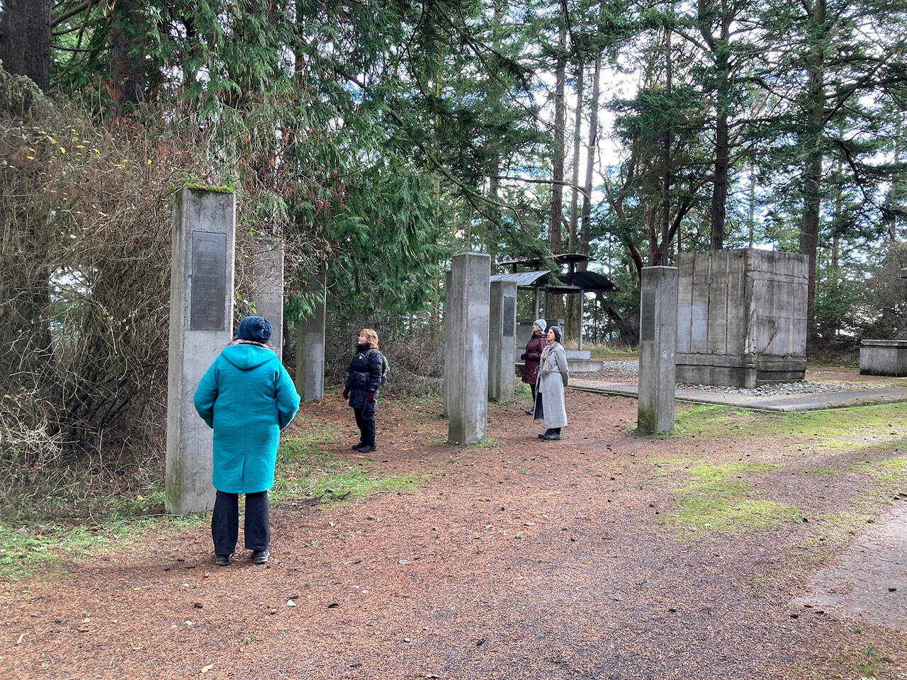 Forest bathing guide Ellen Falconer’s picture of visitors to the Memory’s Vault art installation at Fort Worden is among the photos in a new book. (Ellen Falconer)