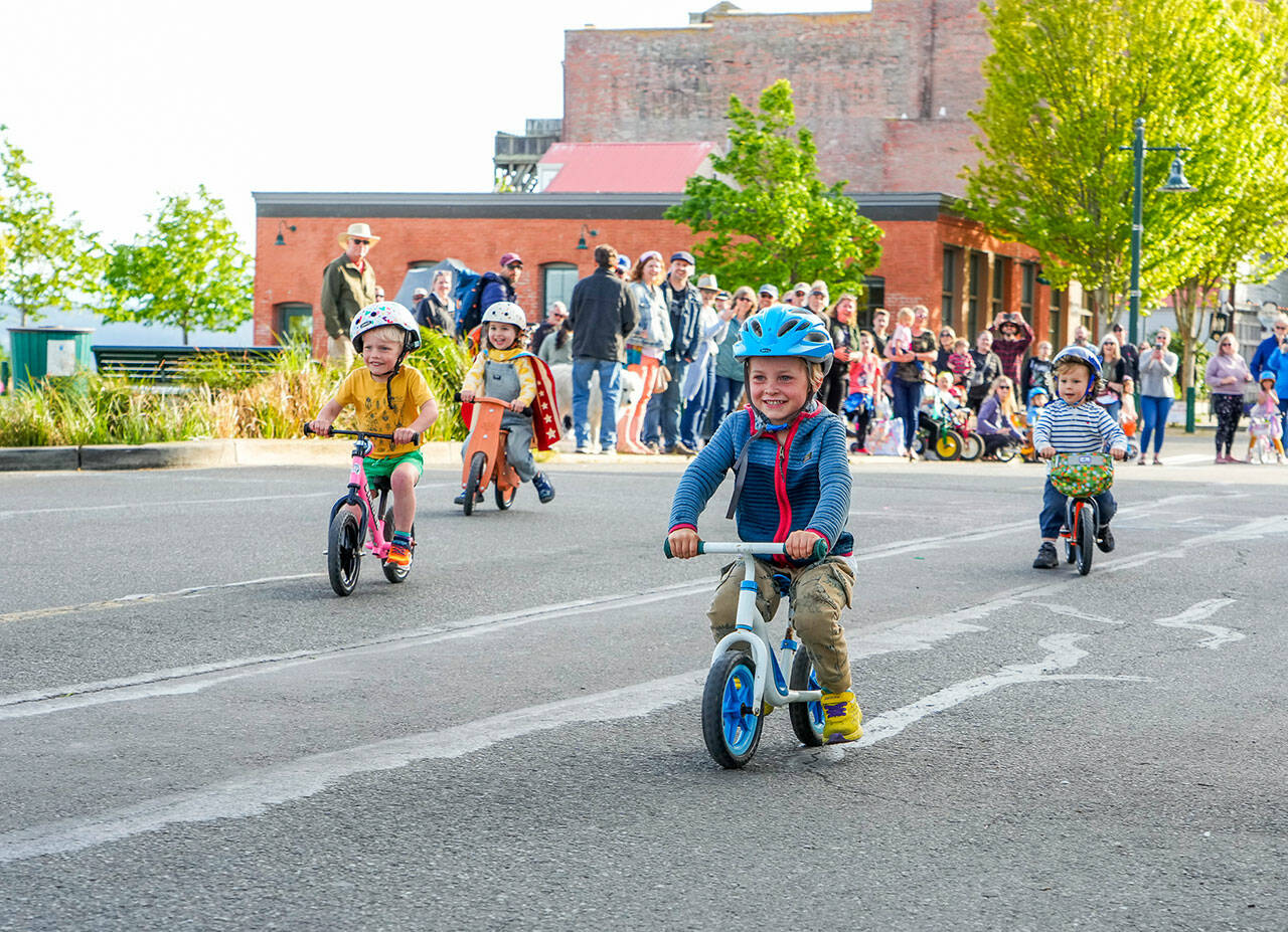 Bear Chashin, 4, wins his age 3-4 trike race during the Rhody Festival Kids Trike Races on Water Street in Port Townsend on Wednesday. The festival continues with a kiddie parade, hair and beard contest and bed races today, plus the grand parade at 1 p.m. Saturday and the Rhody Run at 9 a.m. Sunday. For a complete list of events, go to https://rhodyfestival.org. (Steve Mullensky/for Peninsula Daily News)