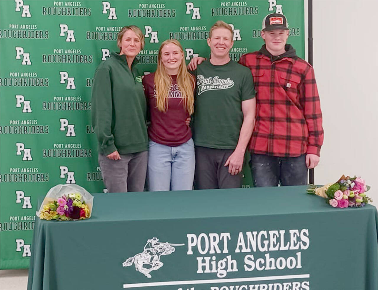 Port Angeles’ Harper McGuire, a district champion in the 200 freestyle and 500 freestyle, signed Wednesday to swim for the University of Puget Sound. From left are mother Karry McGuire, Harper McGuire, father Michael McGuire and brother Ronan McGuire. (Pierre LaBossiere/Peninsula Daily News)