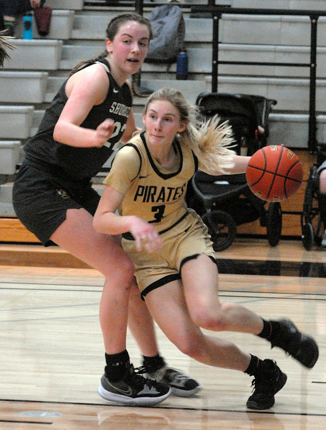 Keith Thorpe/Peninsula Daily News Peninsula’s Millie Long, right, drives past the defense of Shoreline’s Symone Pease during a 2022 contest.
