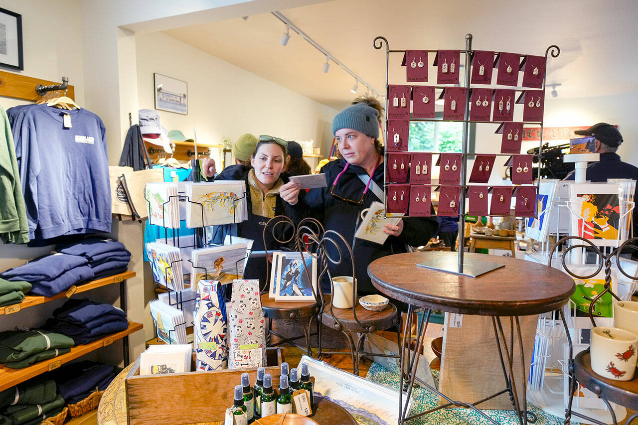 Customers at the Nordland General Store on Marrowstone Island look over cards and other items during a weekend of activities to celebrate the re-opening of the store after it had been closed for six years due to a fire. (Steve Mullensky/for Peninsula Daily News)