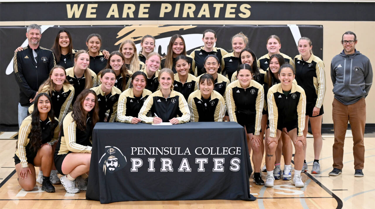 Peninsula College’s Hannah Wagner of Sequim signs to play soccer for Vancouver Island University surrounded by her teammates and assistant coach Andrew Cooper and head coach Kanyon Anderson. Wagner was also the women’s soccer team recipient of the Wally Sigmar and Art Feiro awards for leadership, academics and citizenship. (Peninsula College)