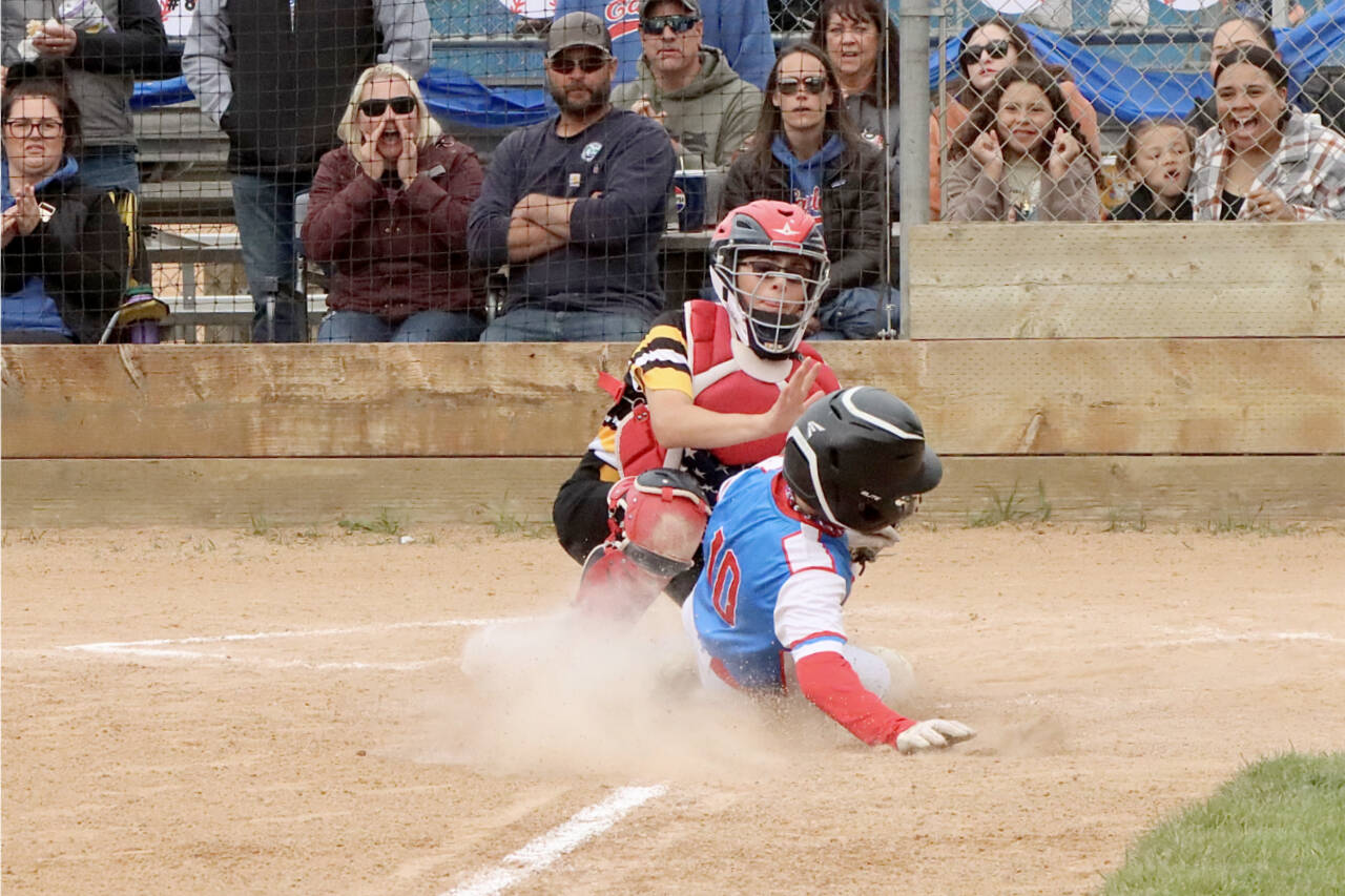 Eagles runner (No. 10) Noah Kiser slides into home hoping to beat the tag of the Elks catcher Kyler Williams, but Williams got the tag down for the out in the Cal Ripken Majors championship game Saturday. (Dave Logan/for Peninsula Daily News)