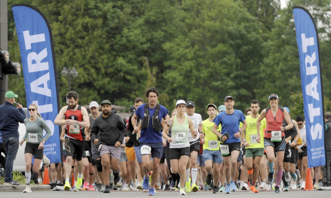 Hundreds of runners take off at 7:30 a.m. Sunday at the 7 Cedars Resort for the North Olympic Discovery Marathon that finished at the Port Angeles City Pier. At left in red is the men’s marathon winner Derek Binnersley. (Michael Dashiell/Olympic Peninsula News Group)