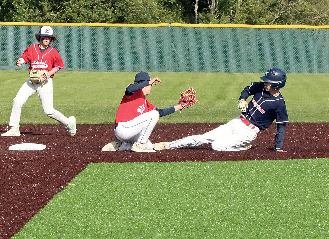 Garret Buerer of the Westport team tries to steal second base on Tuesday night in the Olympic Junior Babe Ruth semifinal, but is put out by Local 155’s Ethan Barbree as he slides. Local 155 second baseman Brayden Scott backs up the play. Westport won 4-0 to qualify for the championship game at 5:30 p.m. Tuesday at Volunteer Park, against the winner of Athlete’s Choice and First Federal. (Dave Logan/for Peninsula Daily News)