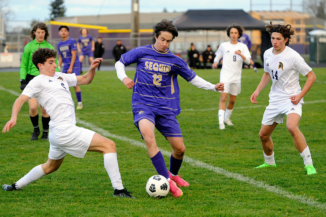 Michael Dashiell/Olympic Peninsula News Group
Sequim's Josh Alcarez, center, avoids two Bainbridge defenders during a March contest. Alcarez was selected to the All-Olympic League first team in voting conducted by league coaches.
