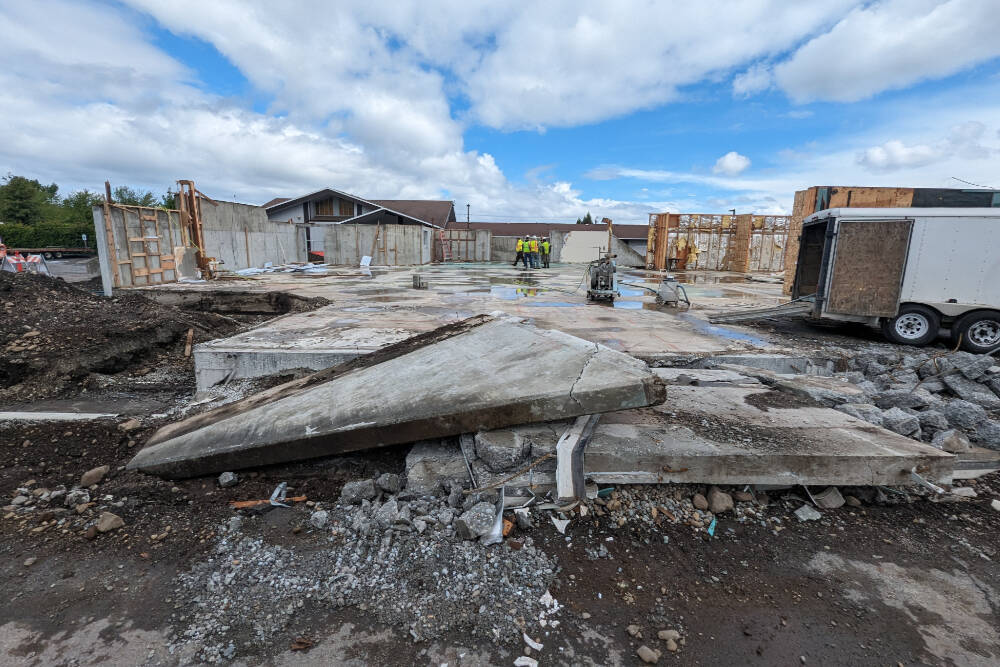 Workers with Hoch Construction remove much of the structure at the Sequim Library location, 630 N. Sequim Ave., in preparation for the major expansion project. (Noah Glaude/North Olympic Library System)