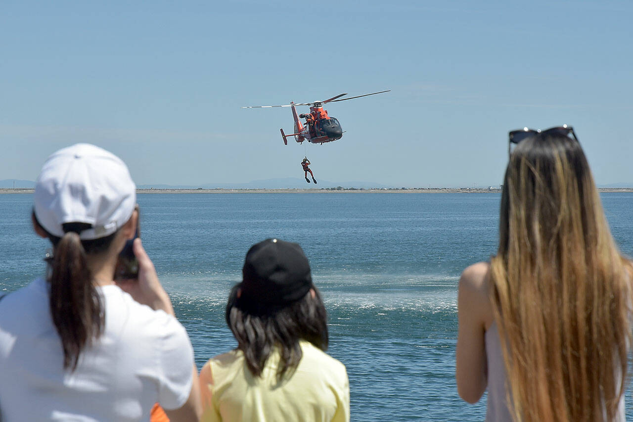 Spectators watch a U.S. Coast Guard rescue drill in Port Angeles Harbor during Saturday’s Maritime Festival along the Port Angeles waterfront. The two-day event, hosted by the Port of Port Angeles, served as a showcase for boating and the maritime trades. (Keith Thorpe/Peninsula Daily News)