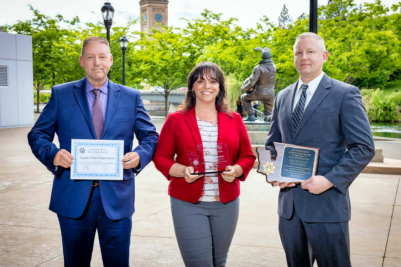 From left, Sequim Deputy Police Chief John Southard, Tiffany Banning and Police Chief Mike Hill received renewed accreditation recognition from the Washington Association of Sheriffs and Police Chiefs.