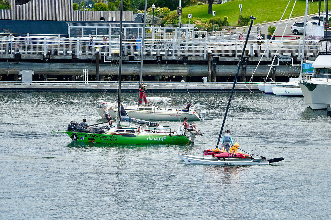 Team Roscoe Pickle Train of Port Townsend, which includes Chris Iruz, Enzo Dougherty, Odin Smith and Pearl Smith, were first out of the Victoria Inner Harbour at the start of the Race to Alaska on Tuesday. The cannon fired at noon and 38 racers headed to Ketchikan, a 750-mile contest that started in Port Townsend on Sunday. (Steve Mullensky/for Peninsula Daily News)