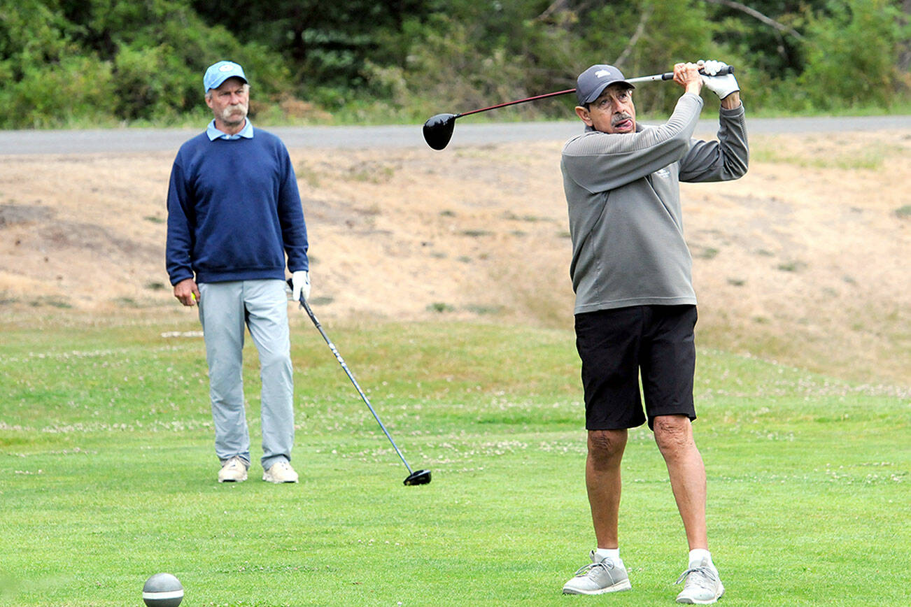 Gary Valencia of Port Angeles, right, tees off at the start of the 2023 Clallam County Amateur tournament last July at Peninsula Golf Club as Scott Hendricks, also of Port Angeles, awaits his turn. (Keith Thorpe/Peninsula Daily News)