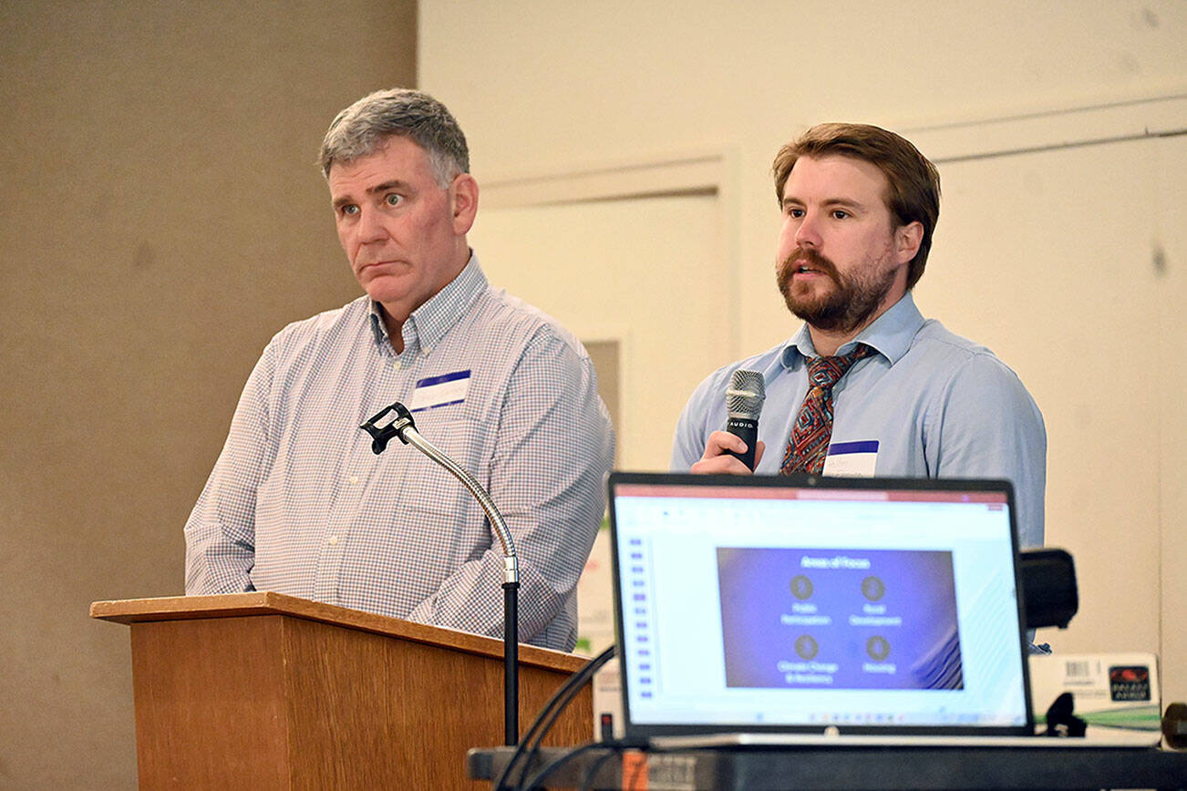 Michael Dashiell /Olympic Peninsula News Group
Bruce Emery, left, and Holden Fleming from the Clallam County Department of Community Development speak to the Sequim-Dungeness Chamber of Commerce on Thursday about the Agricultural Accessory Uses ordinance.