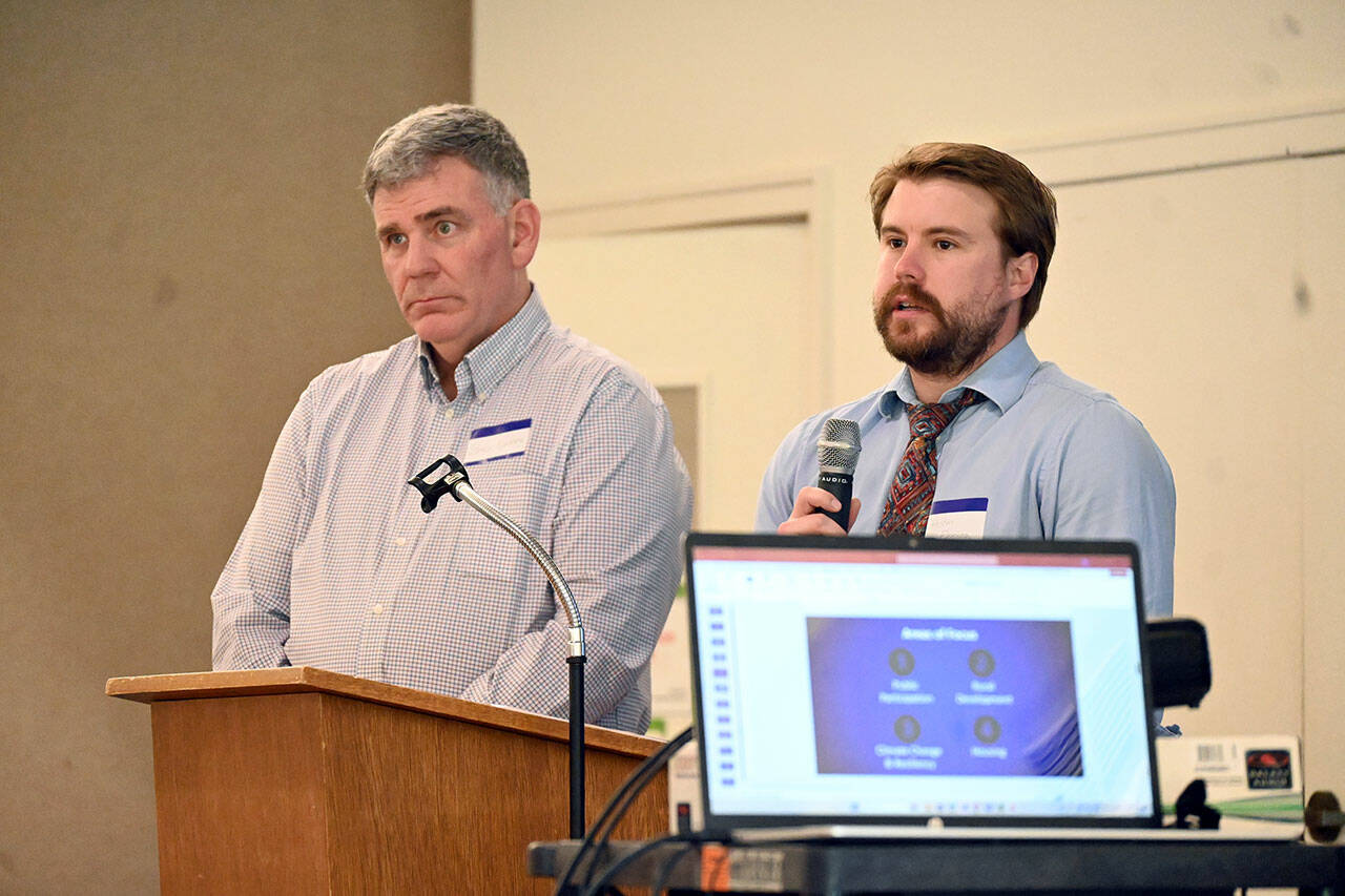 Bruce Emery, left, and Holden Fleming from the Clallam County Department of Community Development speak to the Sequim-Dungeness Chamber of Commerce on Thursday about the Agricultural Accessory Uses ordinance. (Michael Dashiell /Olympic Peninsula News Group)