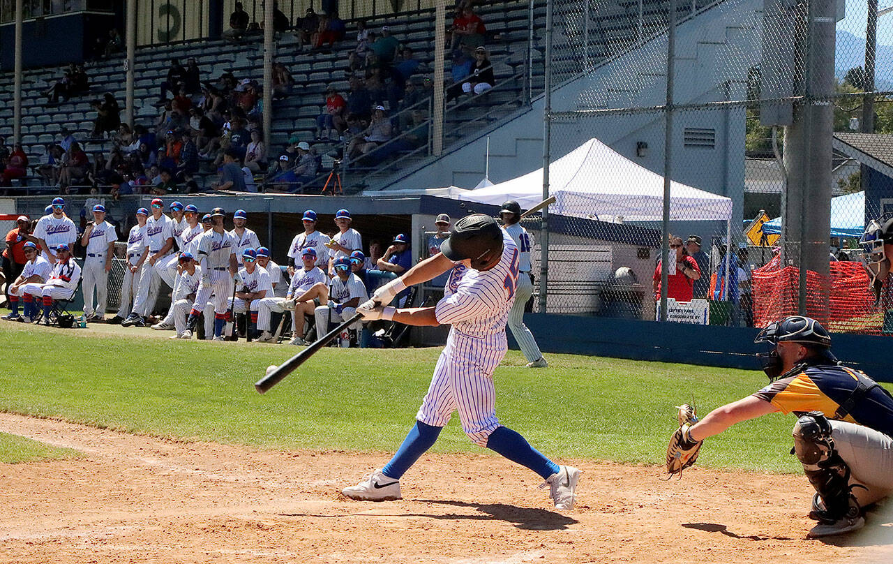 Port Angeles’ Matt Blair gets the bat on the ball in the third inning of their game against the Nanaimo NightHawks. His teammates and fans in the stands at Civic Field watch for a good result at the plate as they celebrate the Fourth of July at the ballpark.
Dave Logan/for Peninsula Daily News