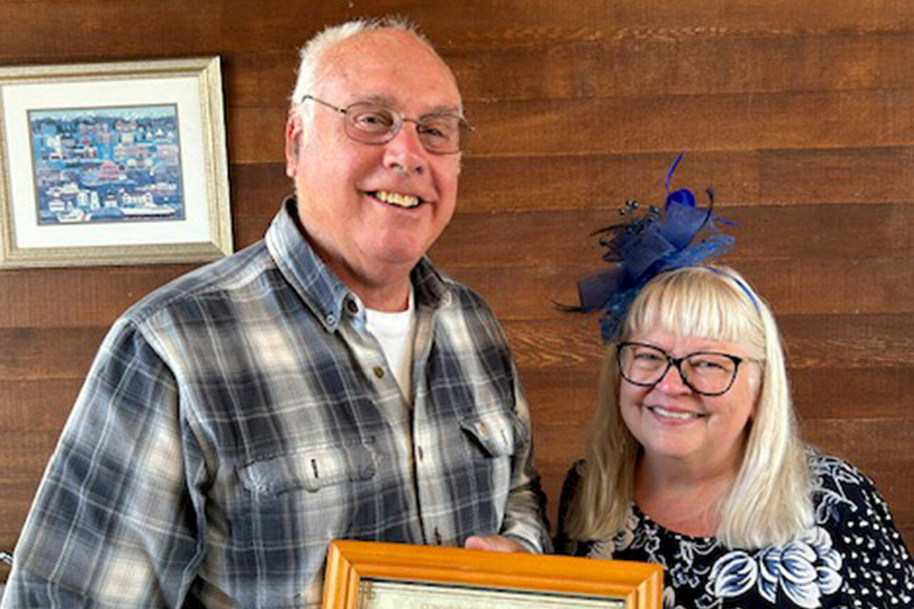 Dan Peacock, on left, receives the 2024 Community Service Award from Lora Brabant, president of the Clallam County School Retirees Association.