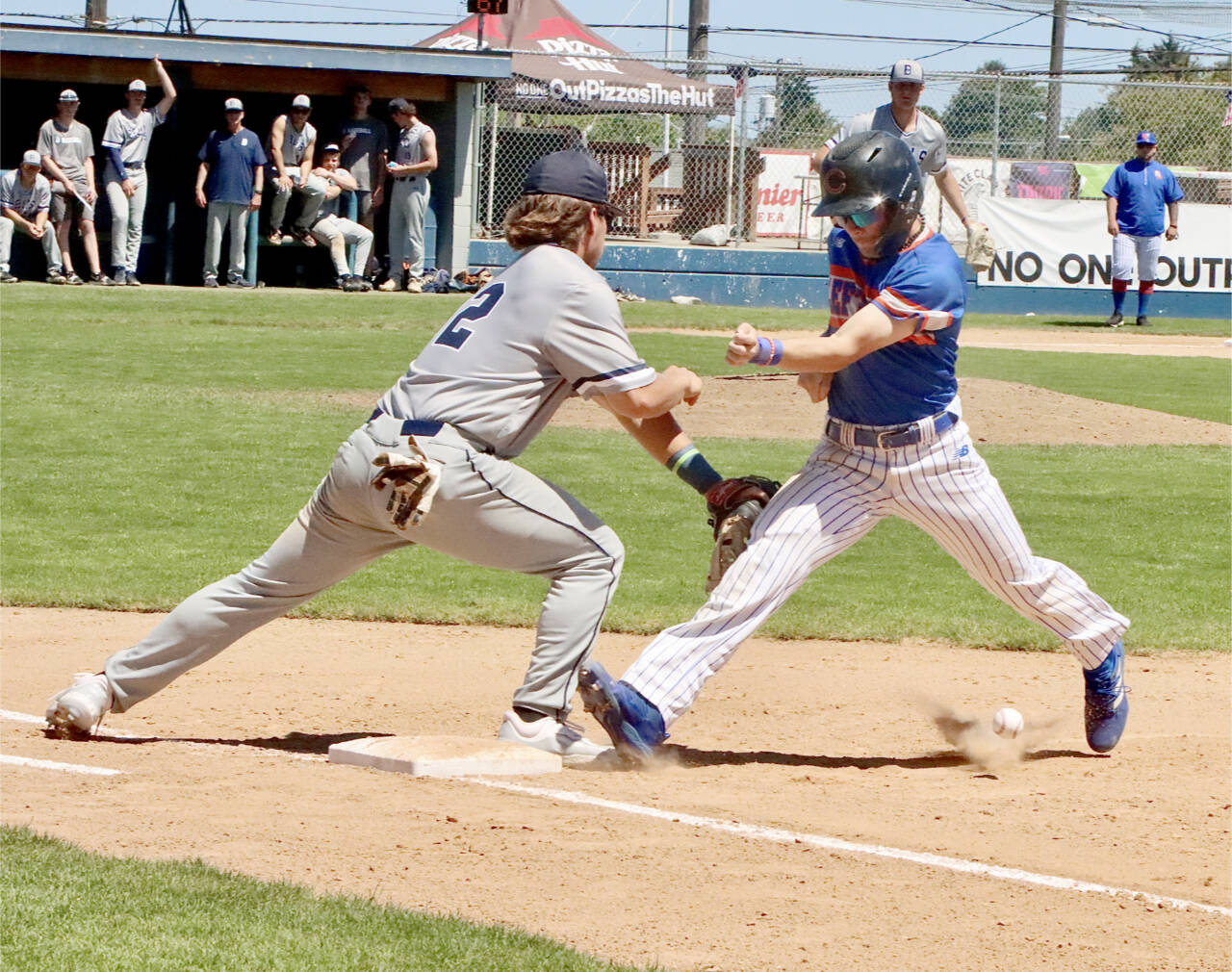 Leftie Yahir Ramirez, pinch-running for Travis Helm, tries to get back to first base on a pickoff move by the Bellingham Bells. The ball sailed into foul territory which resulted in a two-base throwing error. Ramirez ended up scoring from third base on a fly out. (Dave Logan/for Peninsula Daily News)