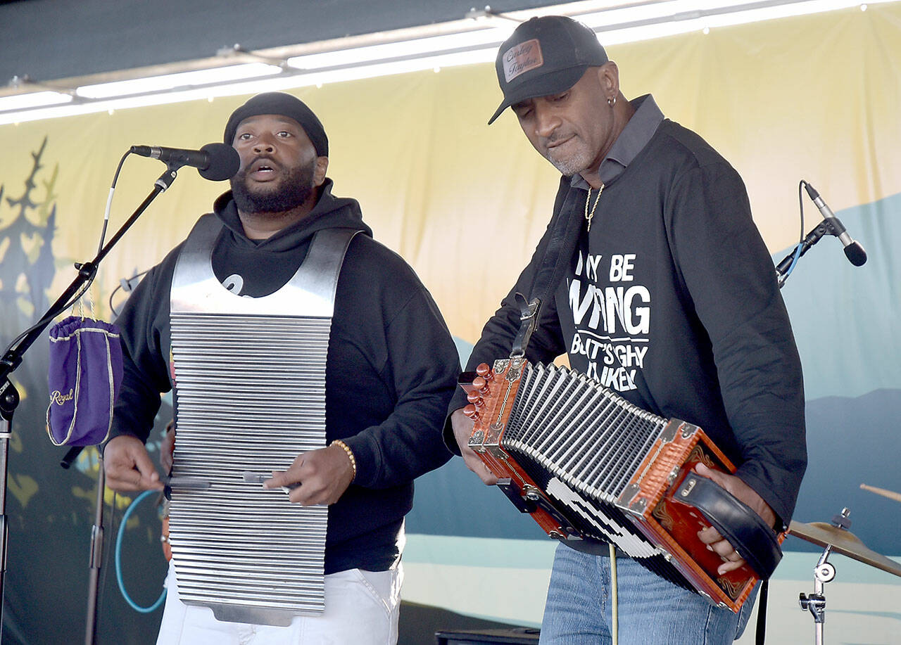 Curley Taylor, frontman of the Louisiana-based band Curley Taylor and Zydeco Trouble (right), performs on a rubboard with bandmate Matthey Roberts during the Concert on the Pier at Port Angeles City Pier on Wednesday night. The free weekly music series, hosted by the Juan de Fuca Foundation and sponsored by Strait View Credit Union, DA Davidson & Co., 102.1 FM The Strait and the Peninsula Daily News, continues Wednesday at 6 p.m. with rock and dance band The Nasty Habits. (Keith Thorpe/Peninsula Daily News)