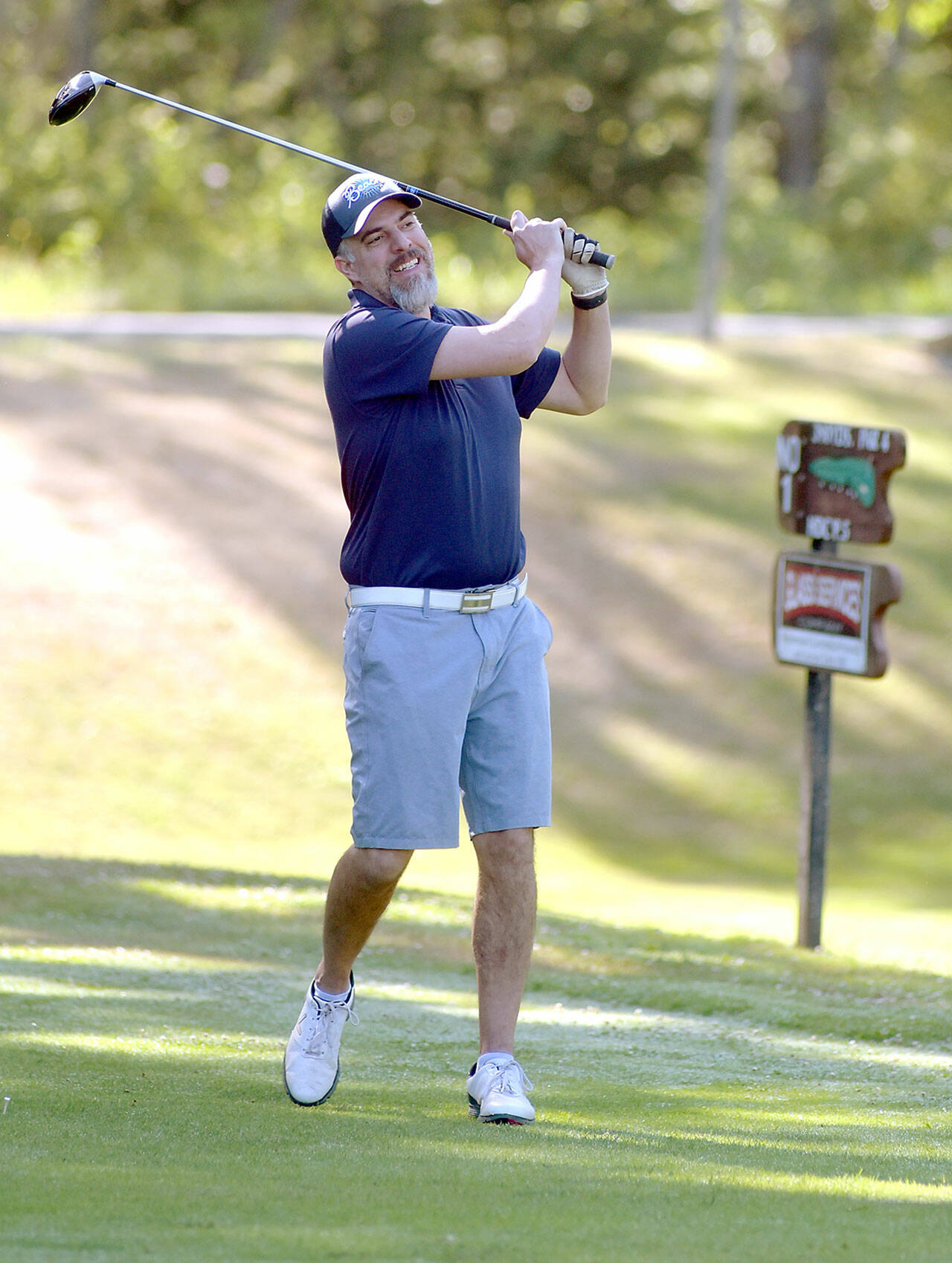 KEITH THORPE/PENINSULA DAILY NEWS Tommy Post, part of a group basing at Sunland, tees off on the first hole of Peninsula Golf Club during Friday’s session of the Clallam County Amateur Championship tournament.