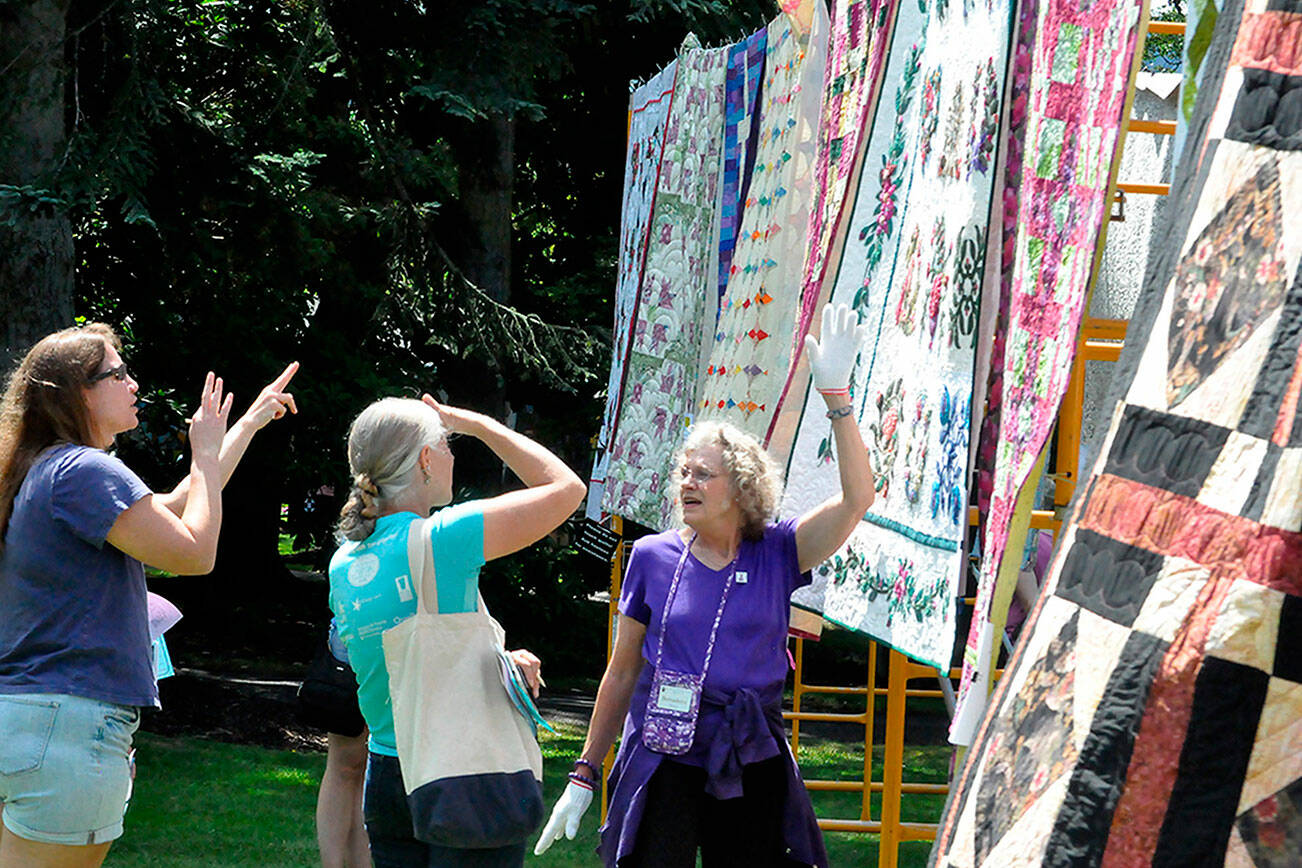 Bernadette Shein helps answer quilt questions for visitors of the Sunbonnet Sue Quilt Club’s annual quilt show in 2023. This year, the event will move to Trinity United Methodist Church and expand to two days, Friday and Saturday. (Matthew Nash/Olympic Peninsula News Group)