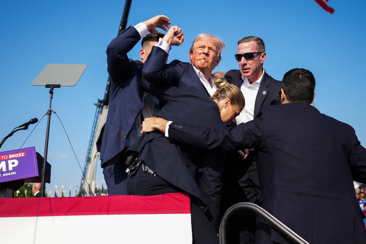 Former President Donald J. Trump is rushed from the stage at a rally in Butler, Pa., on Saturday. (Doug Mills/The New York Times) © 2024 The New York Times Company