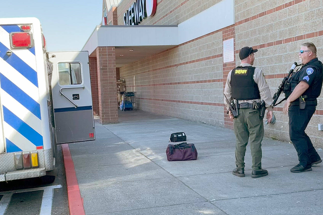 Law enforcement personnel respond to a call Monday afternoon at the Port Angeles Safeway on Lincoln Street after a man threatened homicide and suicide. (Paul Gottlieb/for Peninsula Daily News)