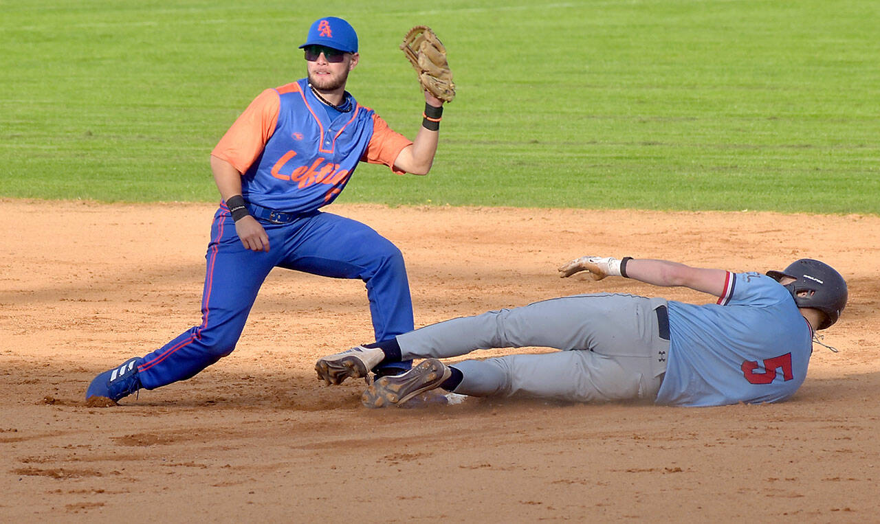 KEITH THORPE/PENINSULA DAILY NEWS Lefties shortstop Yahir Ramirez, left, tags out a Wenatchee player at a game in June at Civic Field. Ramirez hit a double and drove in two runs in a 15-6 win Thursday night over Redmond.