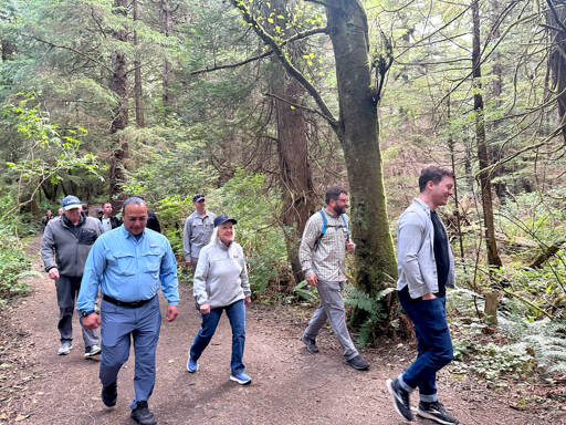 U.S. Sen. Patty Murray, D-Seattle, center, walks on a trail in Neah Bay with Tribal Chairman Timothy J. Greene Sr., left, and others. (Office of Sen. Patty Murray)