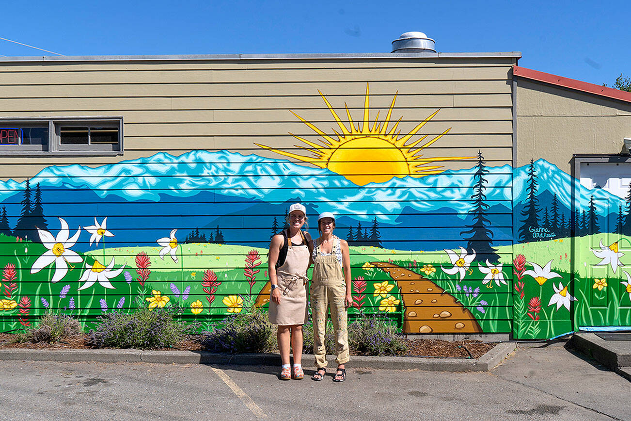 Emily Little, left, owner of Buena Luz Bakery, and artist Gianna Andrews stand in front of the mural.