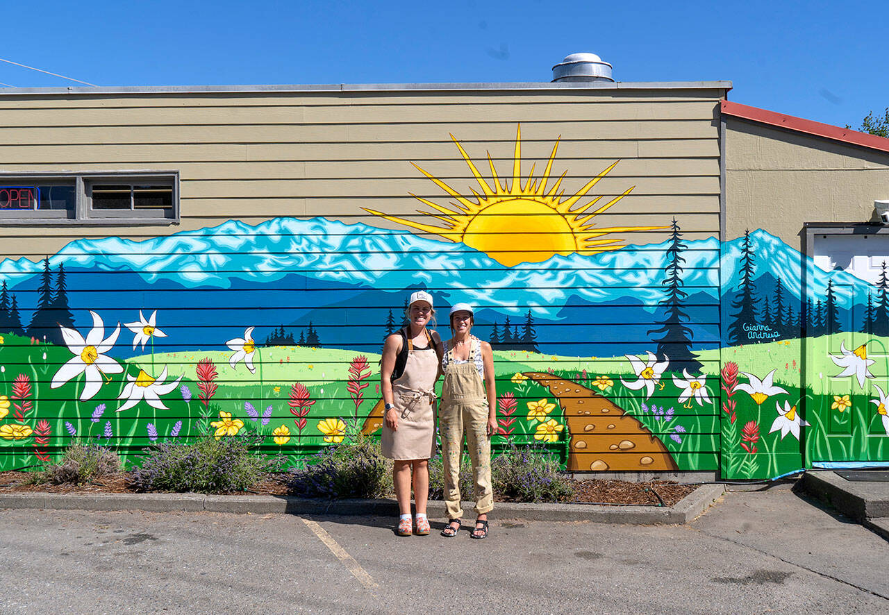 Emily Little, left, owner of Buena Luz Bakery, and artist Gianna Andrews stand in front of the mural.