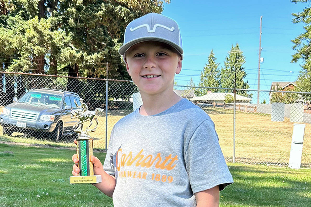 At the end of the Clallam County prefair show, Wes Church received the Biggest Helping Hand Award for helping to keep the barn clean, running errand and giving encouraging compliments. (Photo by Katie Newton)