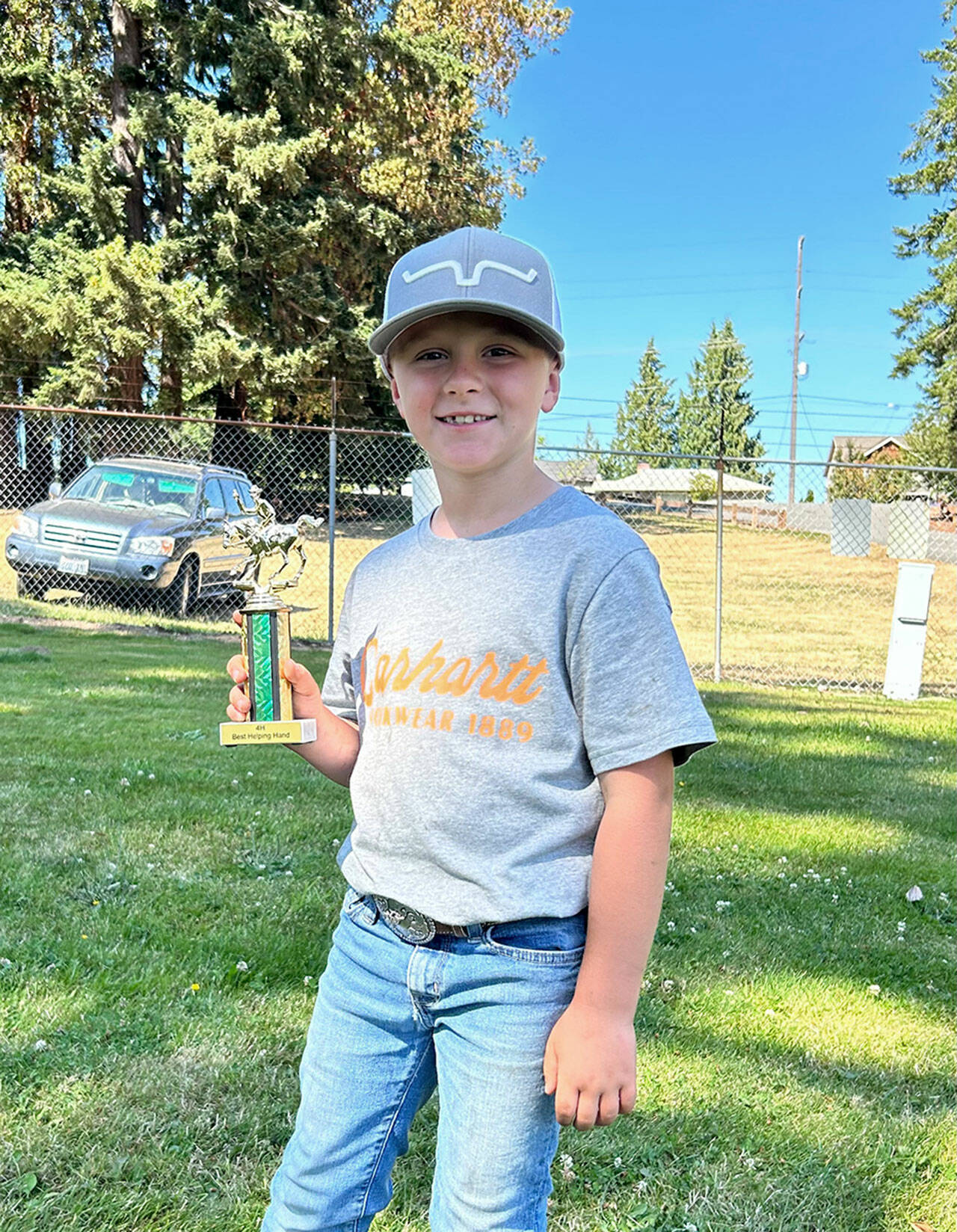 At the end of the Clallam County prefair show, Wes Church received the Biggest Helping Hand Award for helping to keep the barn clean, running errand and giving encouraging compliments. (Photo by Katie Newton)