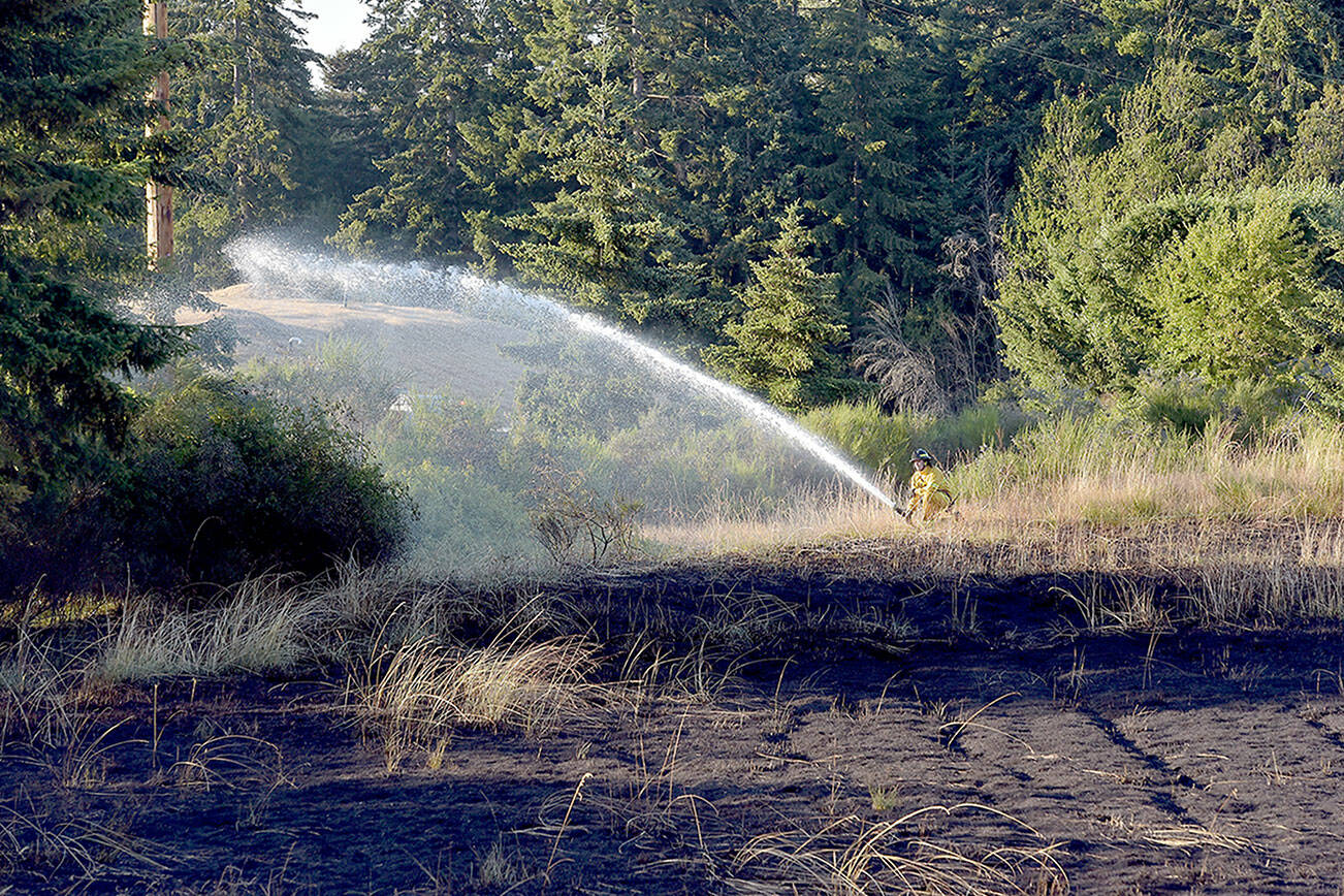 A large brush fire that charred a vacant lot near 13th and K streets on the west side of Port Angeles on Monday underscores the current level of fire danger. (KEITH THORPE/PENINSULA DAILY NEWS)