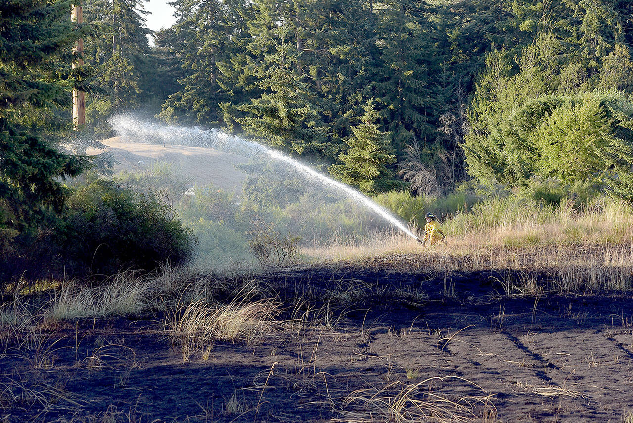 A large brush fire that charred a vacant lot near 13th and K streets on the west side of Port Angeles on Monday underscores the current level of fire danger. (KEITH THORPE/PENINSULA DAILY NEWS)