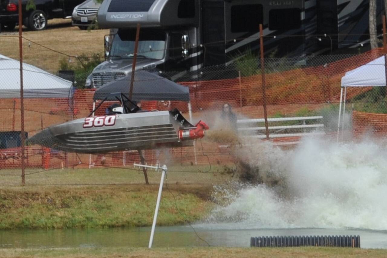 The No. 360 Jolly Roger boat with Chris Farmer driving and Jen Farmer navigating goes airborne after leaving the water at the Extreme Sports Park qualifying Saturday. They crashed into a fence but both driver and navigator got out of the boat. Finals were held Sunday at the Extreme Sports Park. Look in Tuesday’s sports section for final results. (Lonnie Archibald/for Peninsula Daily News)