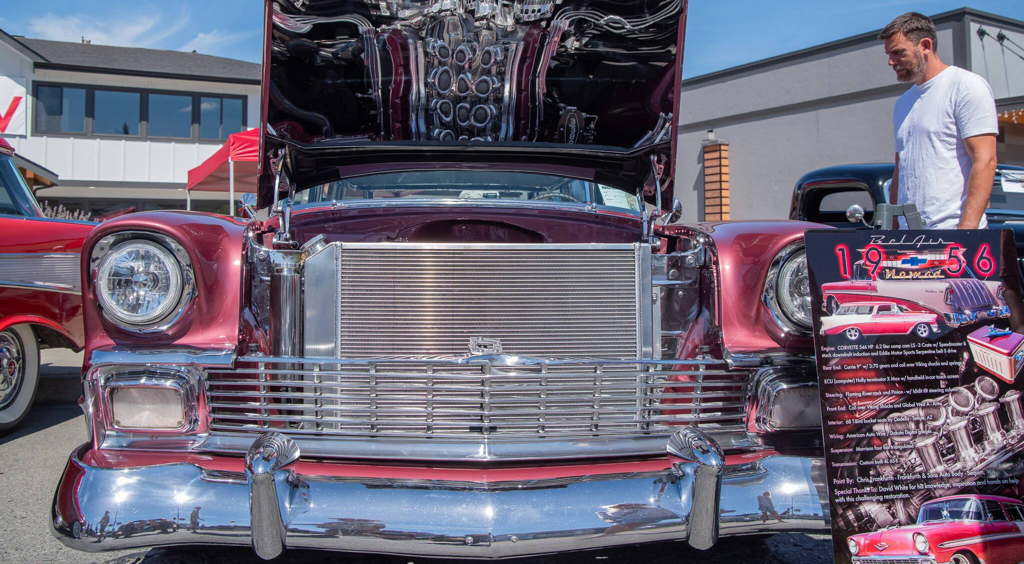 A 1956 Bel Air Nomad attracts passersby with its reflective chrome at the Sequim Prairie Nights Car Show last year. The pattern on the underside of the hood is the reflection of the engine, a Corvette 546 HP. (Emily Matthiessen/Olympic Peninsula News Group)